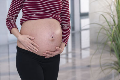 Midsection of woman touching hair