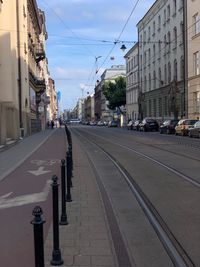 View of city street and buildings against sky