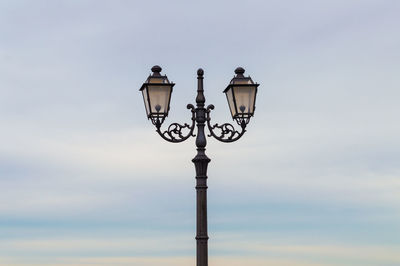 Low angle view of street light against sky