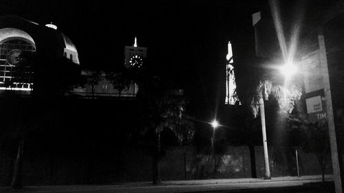 Illuminated city against sky at night