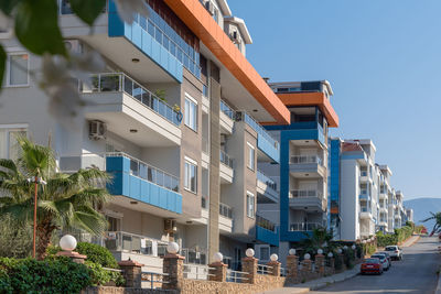 Cityscape of a residential area with modern apartment buildings on a sunny day.