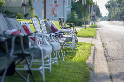 Empty chairs against grass