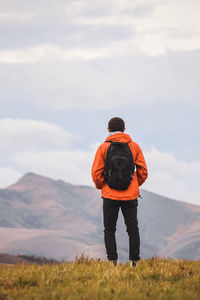 Rear view of man standing on field