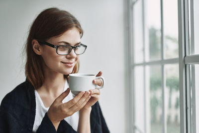 Portrait of woman drinking coffee