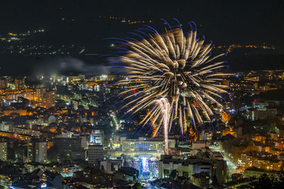 Fireworks above city in the winter nights white