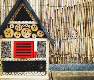 Wooden beehive against fence