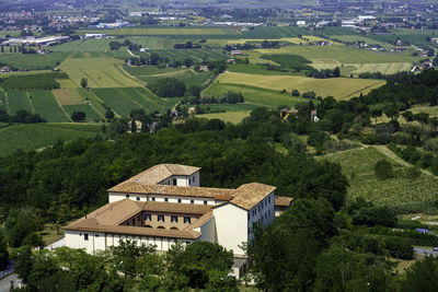 High angle view of houses and trees on field