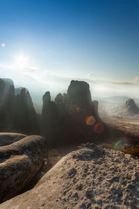 Scenic view of rocks against sky during sunset