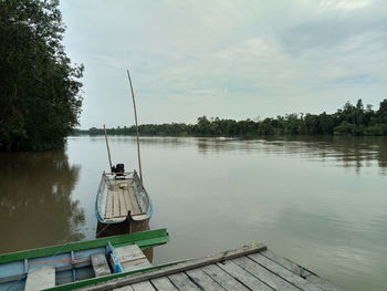 Scenic view of pier on lake against sky