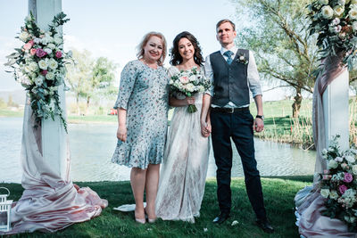 Full length portrait of happy friends standing at park