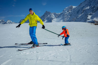 Full length of man skiing on snow covered mountain