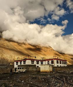 Scenic view of building and mountains against sky