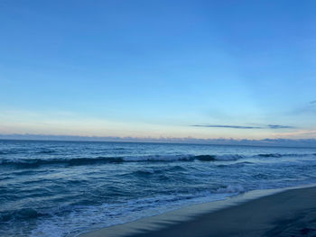 Scenic view of sea against blue sky