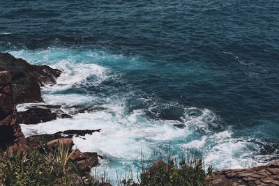 Scenic view of sea by rock formation