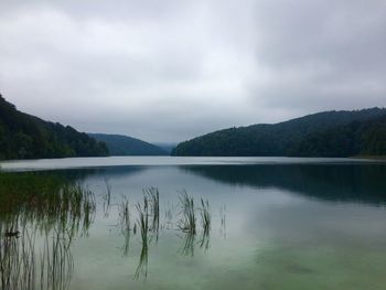 Scenic view of calm lake against mountain range