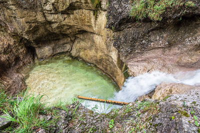 High angle view of waterfall amidst rocks