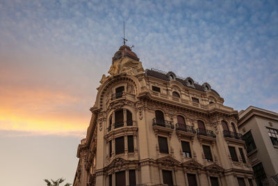 Low angle view of building against sky during sunset