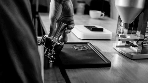 Midsection of man using laptop on table