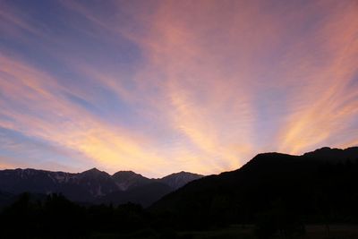 Scenic view of silhouette mountains against sky during sunset