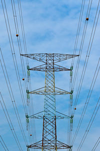 Low angle view of electricity pylon against sky