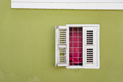 Window on white wall of house