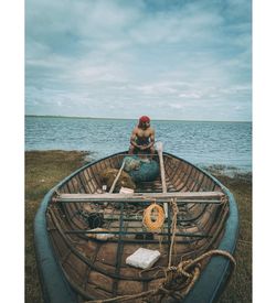 Man on sea shore against sky