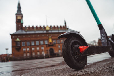 Close-up of vintage car on street against buildings