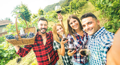 Portrait of smiling friends at vineyard