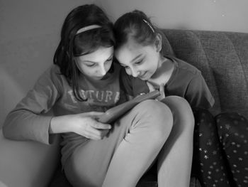 Happy girl sitting on sofa