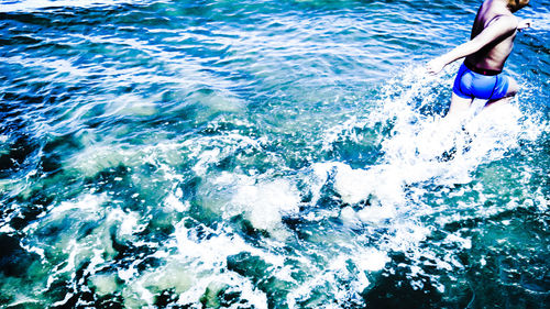 Rear view of man in sea