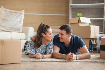 High angle view of siblings sitting on floor at home