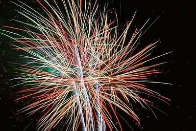 Low angle view of firework display at night