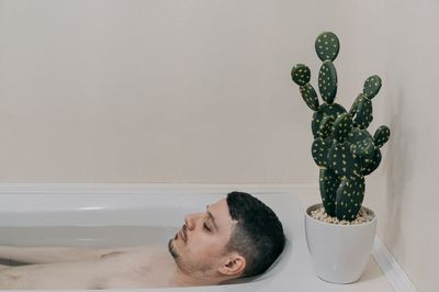 Shirtless man in bathtub