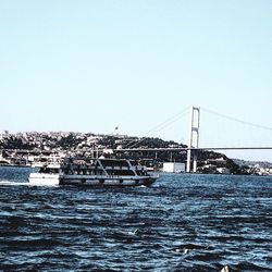 Bridge over sea against clear sky