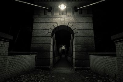Illuminated underground walkway at night