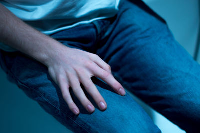 Midsection of man sitting on floor