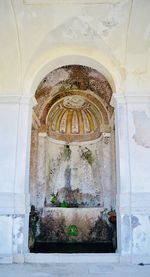 Low angle view of ornate window in old building