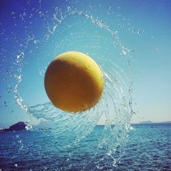 Ball splashing water while spinning over sea