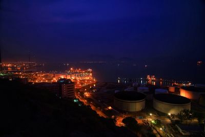 Illuminated cityscape against sky at night