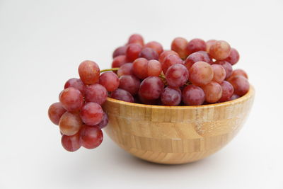 Close-up of grapes against white background