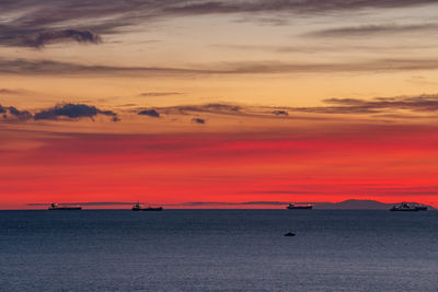 Scenic view of sea against orange sky