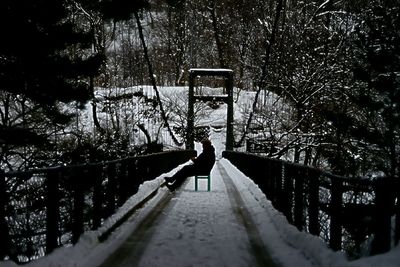 Man walking on footbridge