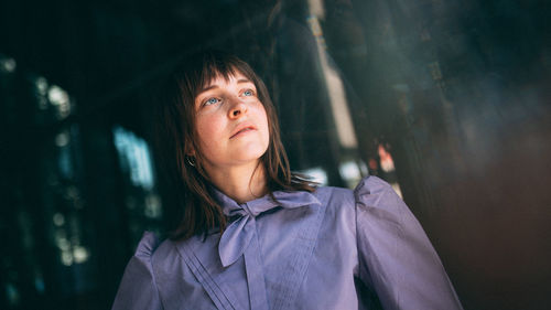 Close-up of beautiful young woman looking away