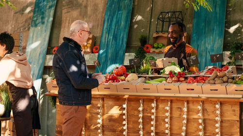 Side view of man working at market stall