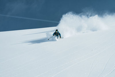 Man enjoying skiing in deep powder snow, gastein, salzburg, austria