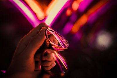 Close-up of hand holding illuminated lights