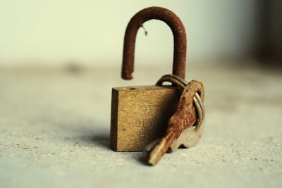 Close-up of rusty padlock with key