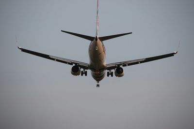 Low angle view of airplane flying against clear sky