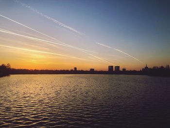 Scenic view of silhouette city against sky during sunset