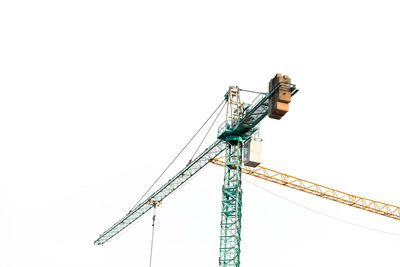 Low angle view of crane against clear sky